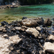 Oil on the rocks at the spill site February 26.